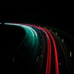 a long exposure photo of a highway at night